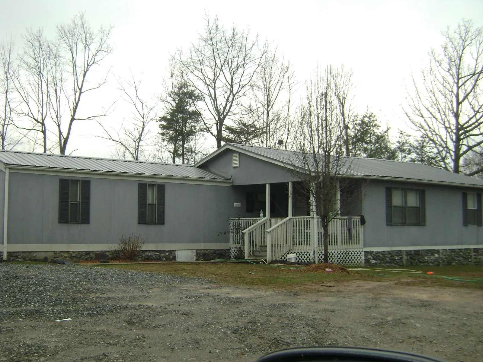 Metal roof over a manufactured home with a covered front porch in Bassett